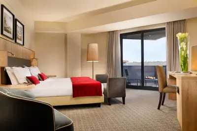 a hotel room with a bed and a large window at A.Roma Lifestyle Hotel in Rome