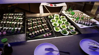 a buffet of sushi and other food on display at A.Roma Lifestyle Hotel in Rome