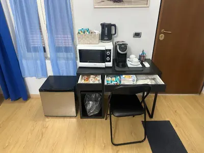 a table with a microwave and a coffee maker at Alloggio Fiorella in Rome