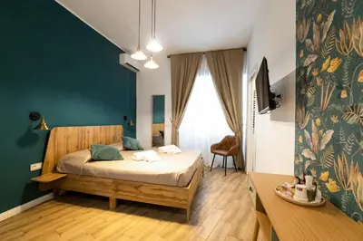 a bedroom with a bed and a desk in a room at Be Max Guest House in Rome