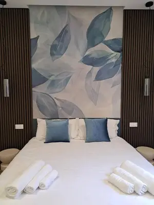 a bedroom with a bed with two towels on it at Deltis Boutique Apartments in Rome