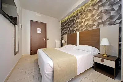 a bedroom with a large bed and a flat screen tv at Roma Suite Centro in Rome