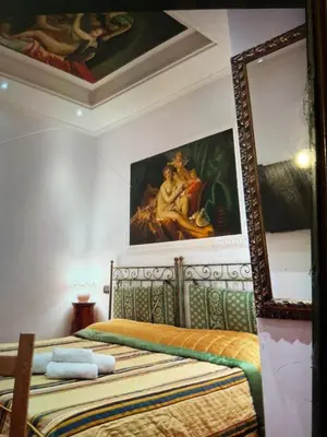 a bedroom with a bed with a painting on the wall at Sancta Scala in Rome