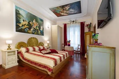 a bedroom with a bed and a painting on the wall at Sancta Scala in Rome