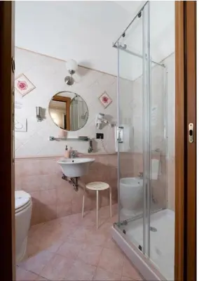 a bathroom with a shower and a sink and a toilet at Sancta Scala in Rome