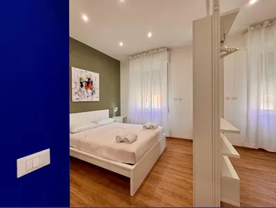 a bedroom with a bed and a room with a window at JHHIT - Panoramic Modern Penthouse in Rome