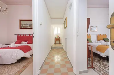 a hallway with two beds in a room at 4BNB - Monteverde Chic & Comfort in Rome