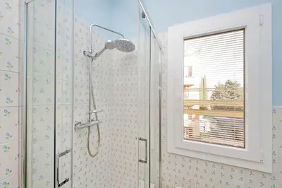 a shower in a bathroom with a window at 4BNB - Monteverde Chic & Comfort in Rome