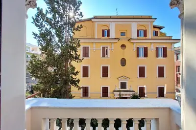 a yellow building seen through a window at 4BNB - Monteverde Chic & Comfort in Rome
