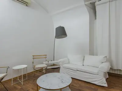 a living room with a white couch and a table at Apartment Plinio by Interhome in Rome