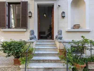 two statues on the front steps of a house at Apartment Plinio by Interhome in Rome
