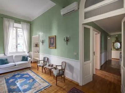 a living room with green walls and a white couch at Apartment Plinio by Interhome in Rome