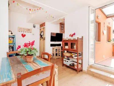 a living room with a table and a dining room at Apartment La Terrazza by Interhome in Rome