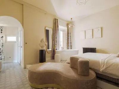 a bedroom with a large bed and a bath tub at Apartment La Dolce Vita by Interhome in Rome