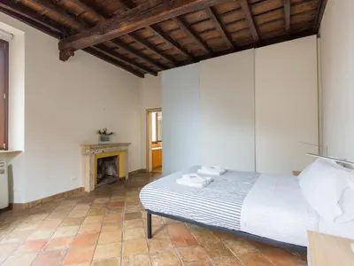 a bedroom with a bed and a fireplace at Apartment Pantheon View by Interhome in Rome