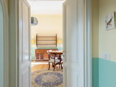 a door leading into a room with a table and chair at Apartment Babuino by Interhome in Rome