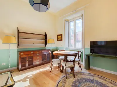 a living room with a table and a tv at Apartment Babuino by Interhome in Rome