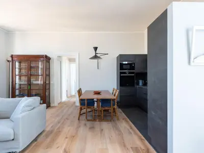 a kitchen and living room with a table and a couch at Apartment Luminosa Vittoria by Interhome in Rome