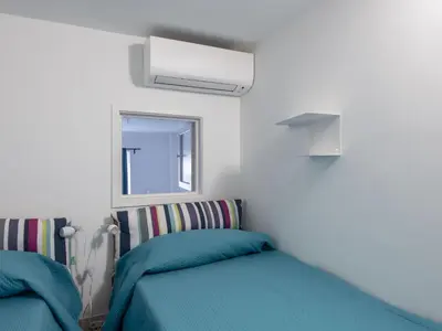 a bedroom with two beds and a window at Apartment Il Nido by Interhome in Rome