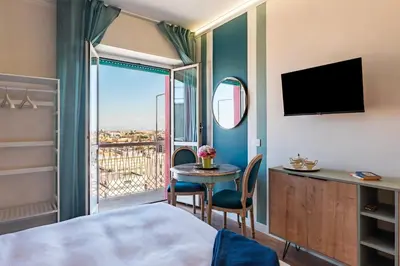 a hotel room with a bed and a table and a window at YCH-Ponte Lungo apartment in Rome