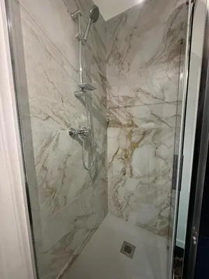 a bathroom with a shower with a glass door at Residenza Piramide in Rome