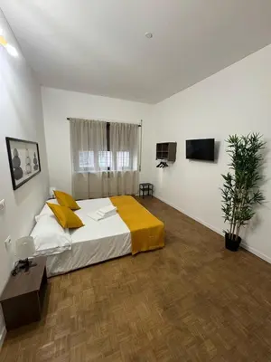 a bedroom with a large bed with yellow pillows at Residenza Piramide in Rome