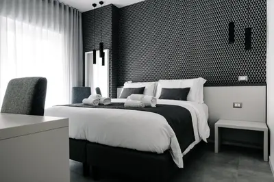 a black and white bedroom with a large bed at B&B Lumas Up in Rome