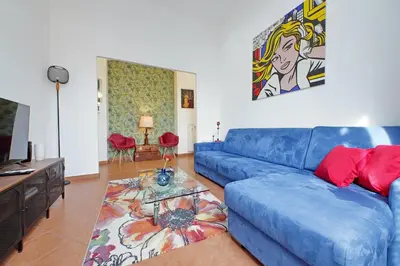 a blue couch in a living room with a table at Vatican 47 in Rome