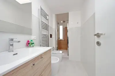 a white bathroom with a sink and a toilet at Vatican 47 in Rome