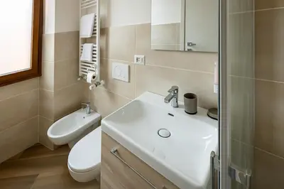 a bathroom with a white sink and a toilet at Il balconcino di Emma in Rome