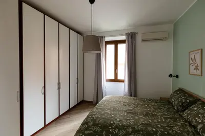 a bedroom with a bed and a window at Il balconcino di Emma in Rome