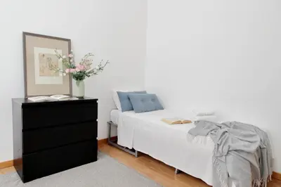 a bedroom with a bed and a dresser with a mirror at Giuliana Vatican Family Home in Rome