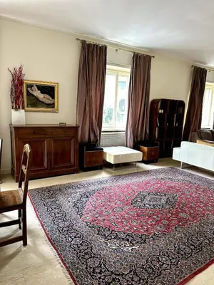 a living room with a large rug on the floor at Dimora XIX in Rome