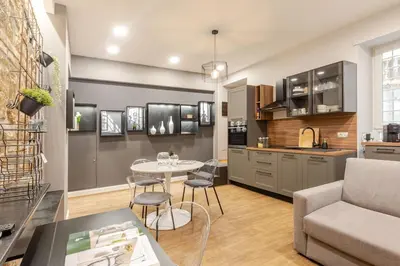 a kitchen and living room with a table and a couch at Appartamento My Happy Place Rome in Rome