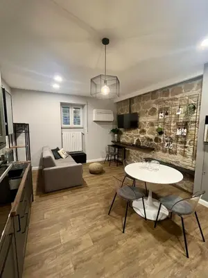 a living room with a table and a couch at Appartamento My Happy Place Rome in Rome