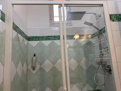 a shower with a glass door in a bathroom at Domi 10 Apartment, Stazione Termini, Via Curtatone 12 in Rome