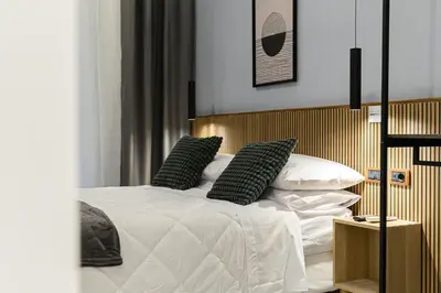 a bedroom with a bed with white sheets and pillows at Arte di Roma - Guest House in Rome