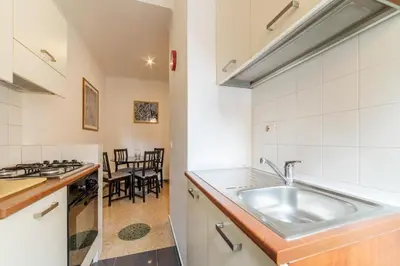 a kitchen with a sink and a table with chairs at GuestHost - Piazza Bologna Apartment in Rome