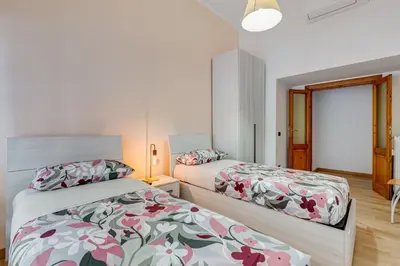 a bedroom with two beds and a window at 3-Bedroom Home Near Trastevere Station in Rome