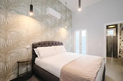 a bedroom with a bed and a wall at Domus Matris Guest House in Rome