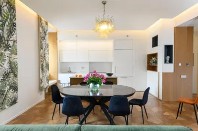 a dining room and kitchen with a table and chairs at Moon River Luxury Apartment in Rome