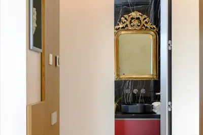 a door with a mirror and a sink at Moon River Luxury Apartment in Rome