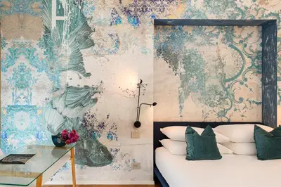 a bedroom with a bed and a wall mural at Moon River Luxury Apartment in Rome