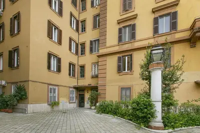 a large yellow building with a street in front of it at Family Stay in Trastevere in Rome