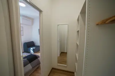 a hallway with a mirror and a room with a bed at Casa Stefano at the Vatican comfort in the Heart of Rome in Rome