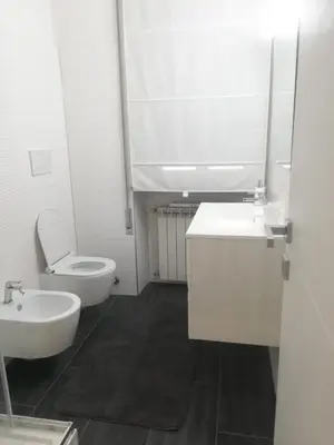 a bathroom with a sink and a toilet and a mirror at New Jebs sweet home Rome in Rome