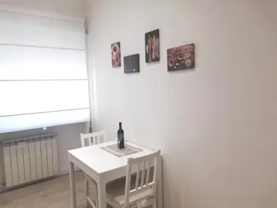 a white table and chairs with a bottle of wine on it at New Jebs sweet home Rome in Rome