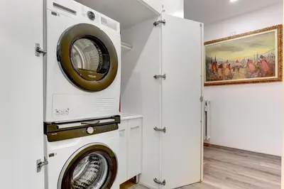 a washer and dryer in a white laundry room at Marconi APT per Famiglie - 20 Min dal centro in Rome