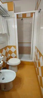a bathroom with two toilets and a shower at Soggiorno Fenicia in Rome