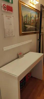 a white desk in a room with a painting on the wall at Soggiorno Fenicia in Rome